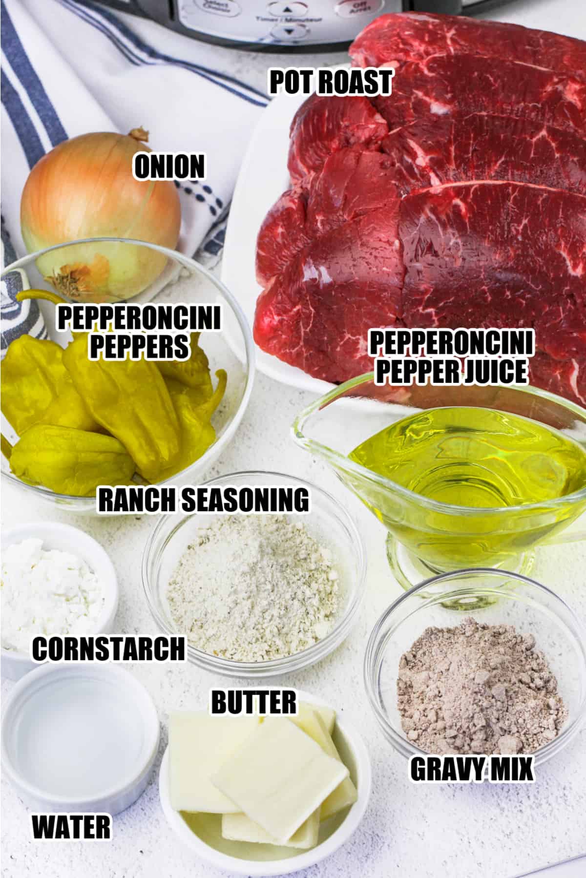 ingredients for slow cooker Mississippi pot roast including pot roast, onion, pepperoncini peppers, pepperoncini pepper juices, ranch seasoning, cornstarch, water, butter, and gravy mix