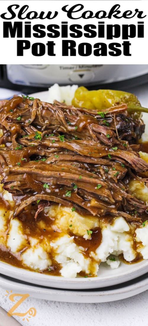 slow cooker Mississippi pot roast on a plate with mashed potatoes and gravy with writing