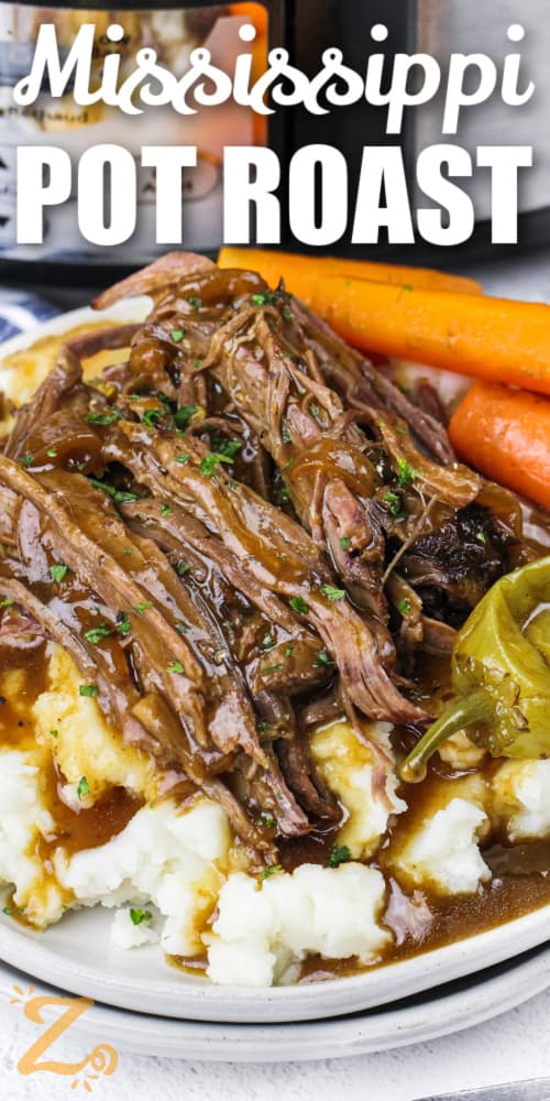 slow cooker Mississippi pot roast on a bed of mashed potatoes with a title
