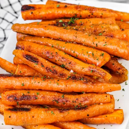 Oven Roasted Carrots on a plate with parsley as garnish