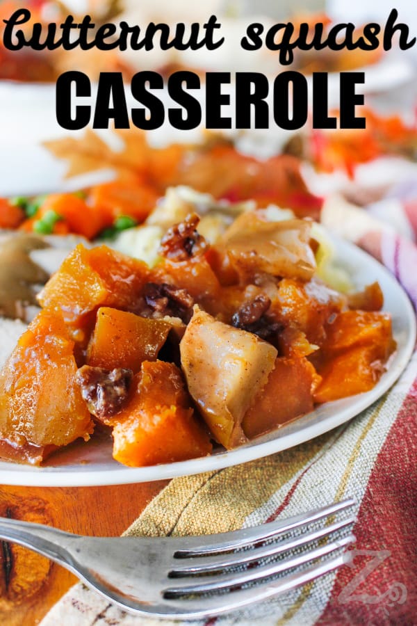 butternut squash casserole on a plate with a fork on the side and writing