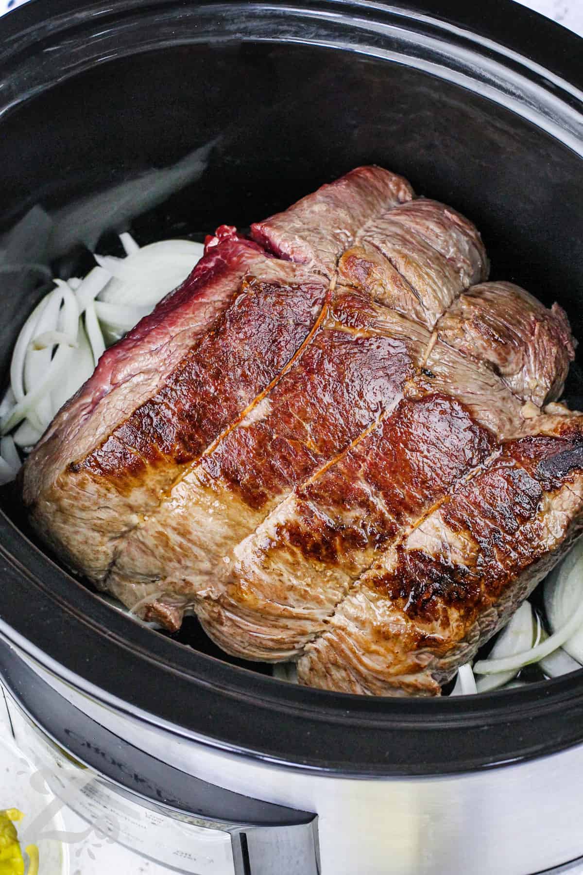 pot roast in a slow cooker with onions for slow cooker Mississippi pot roast