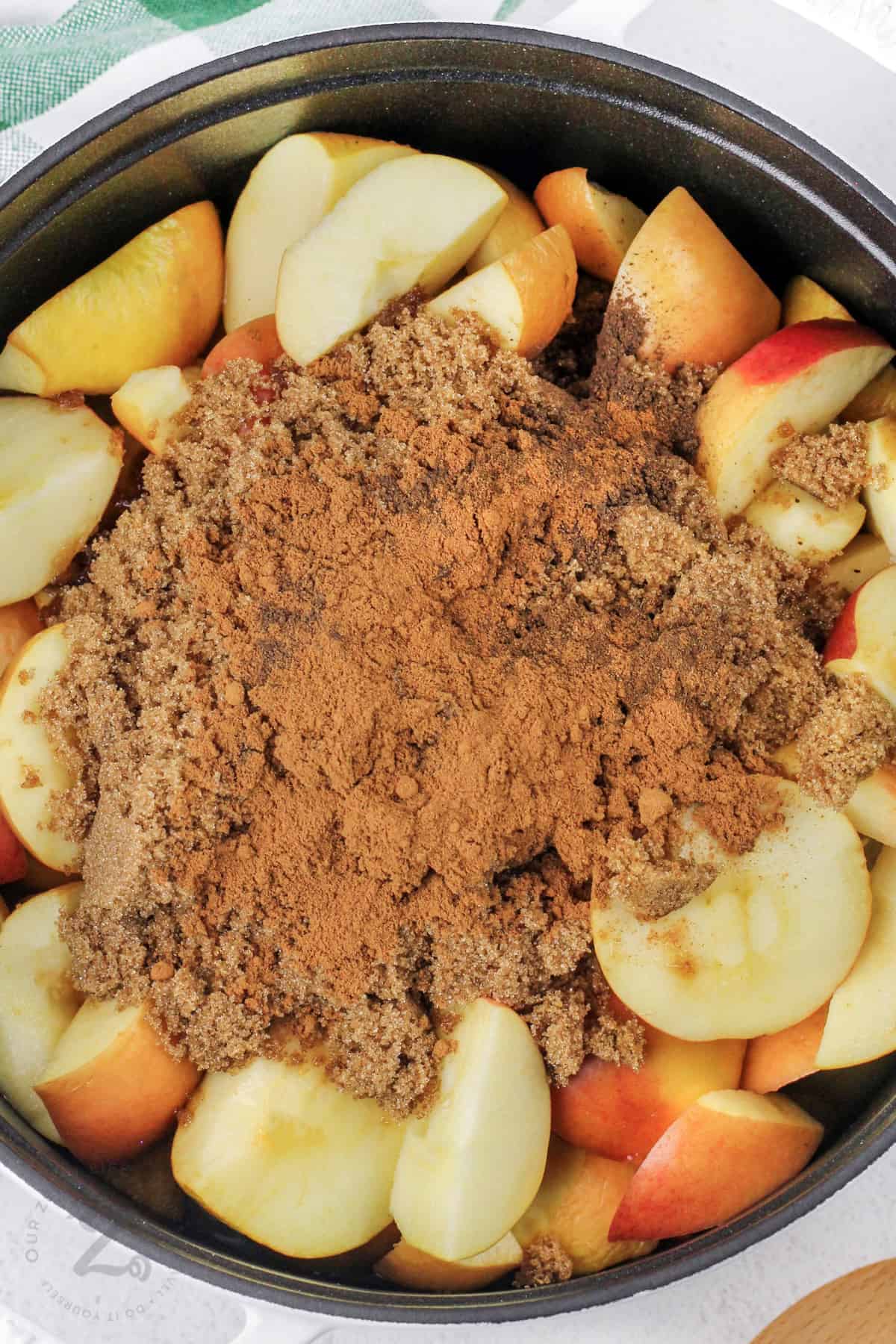 adding spices to apples to make Apple Butter