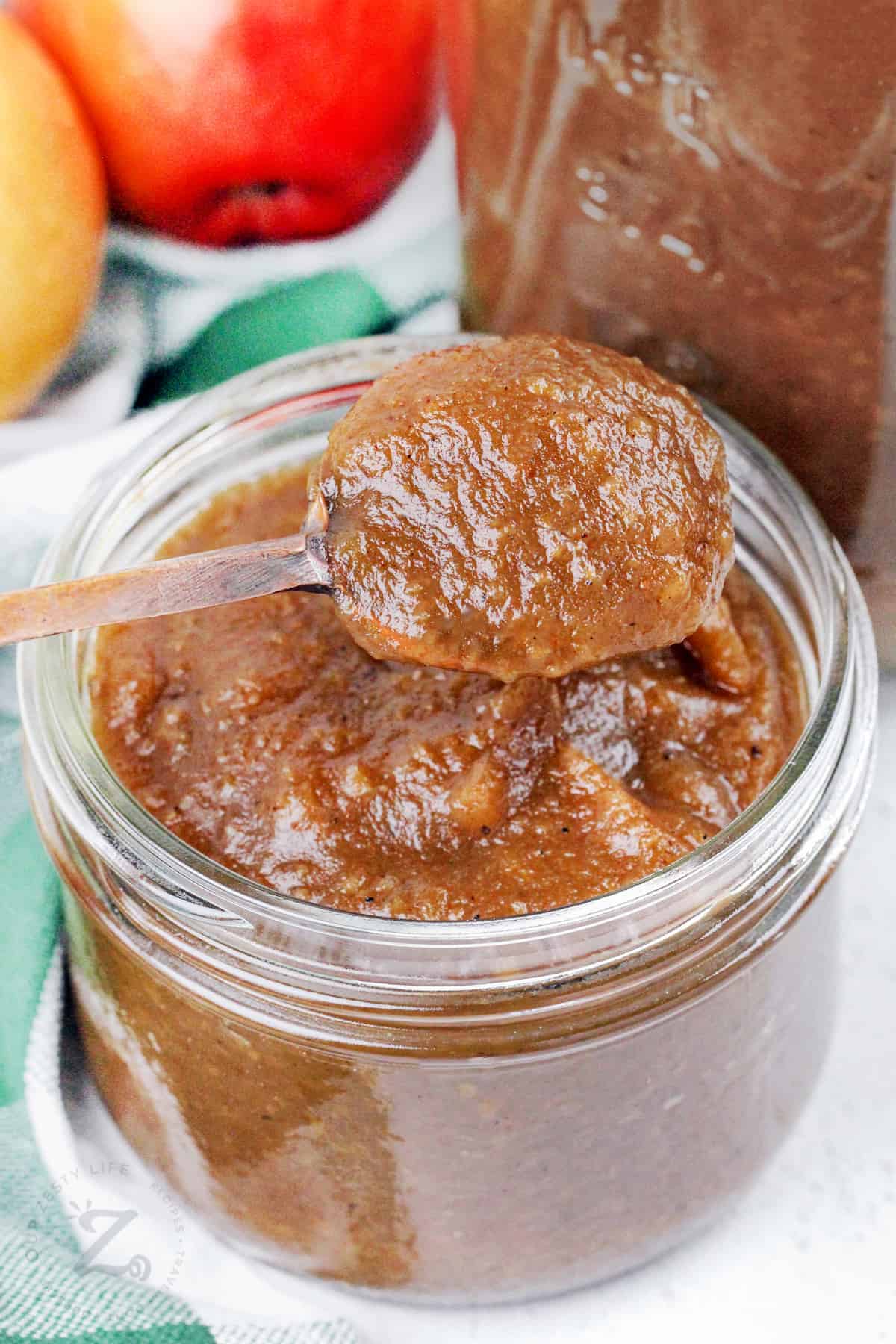 taking a spoonful of Apple Butter our of the jar