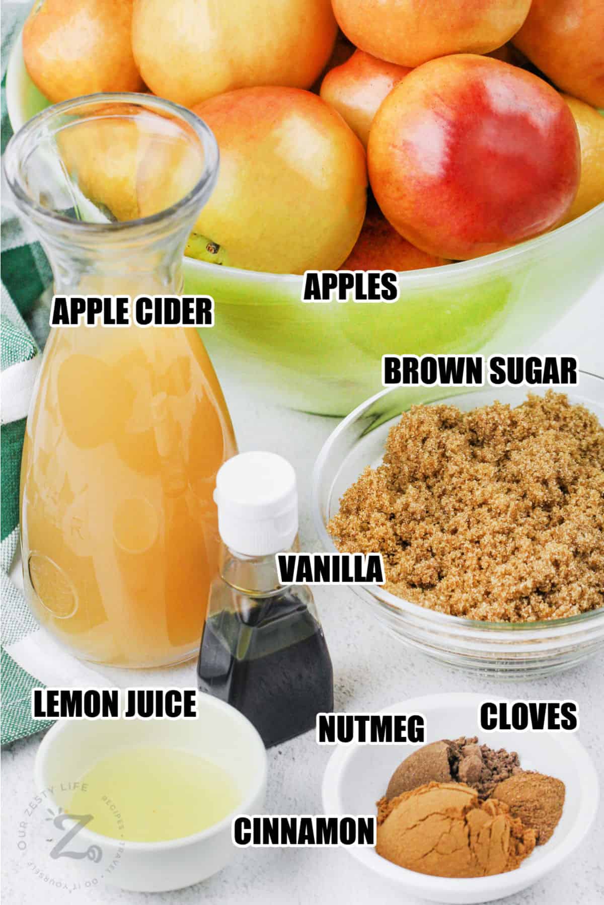 apple cider , apples , brown sugar , vanilla , lemon juice , cinnamon , nutmeg and cloves with labels to make Apple Butter