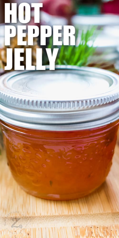 mason jar full of red pepper jelly with writing