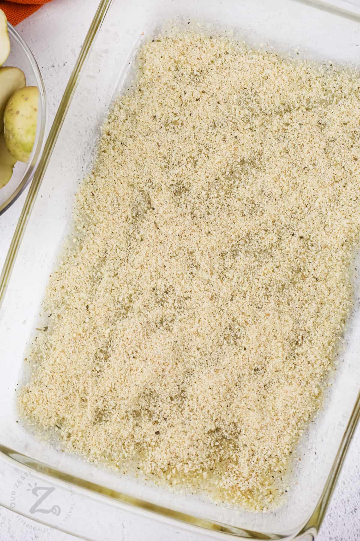 parmesan mixture in a glass dish for Parmesan Roasted Potatoes