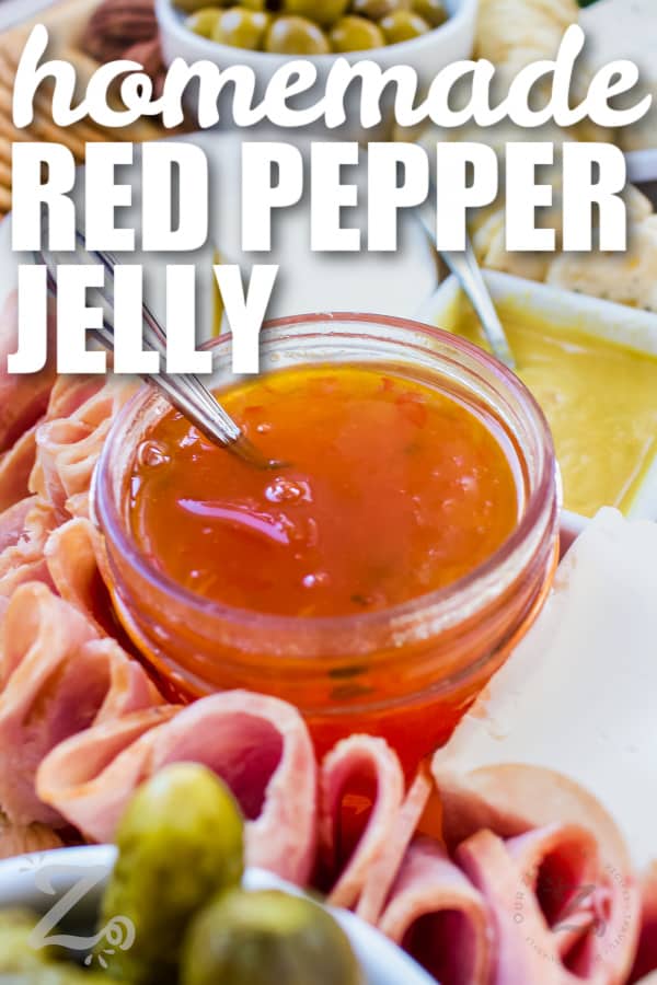 red pepper jelly in a jar with a spoon and writing