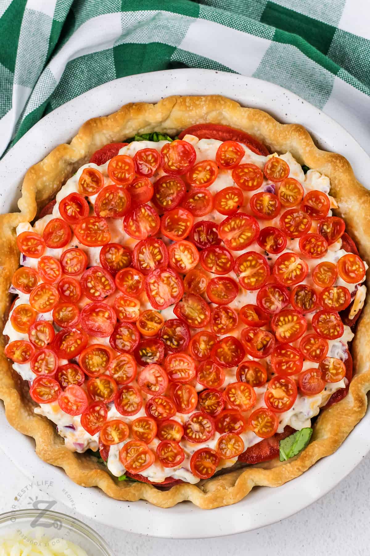 layer of tomato pie with tomatoes on top