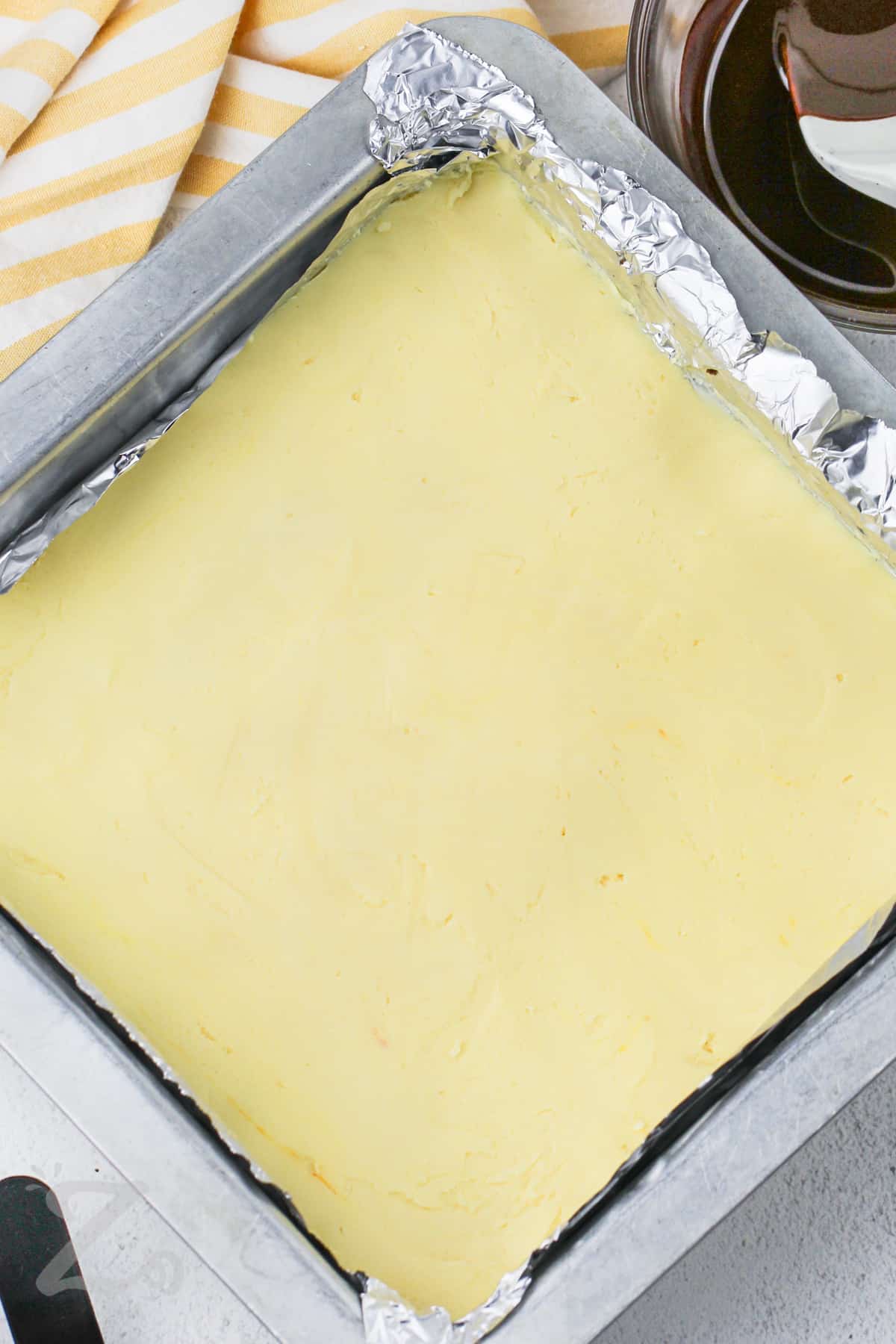 custard layer in a pan for Nanaimo Bars