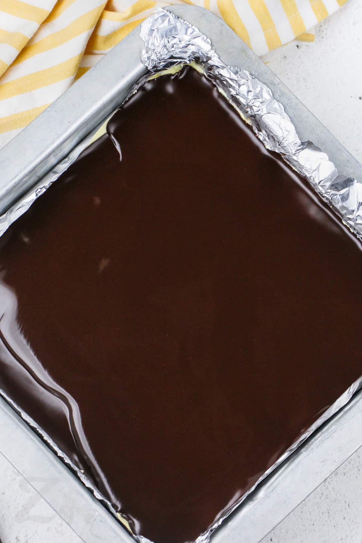 chocolate layer in a pan for Nanaimo Bars