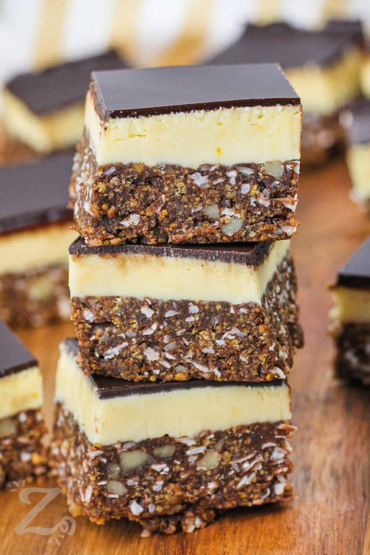 stack of Nanaimo Bars on a wooden board