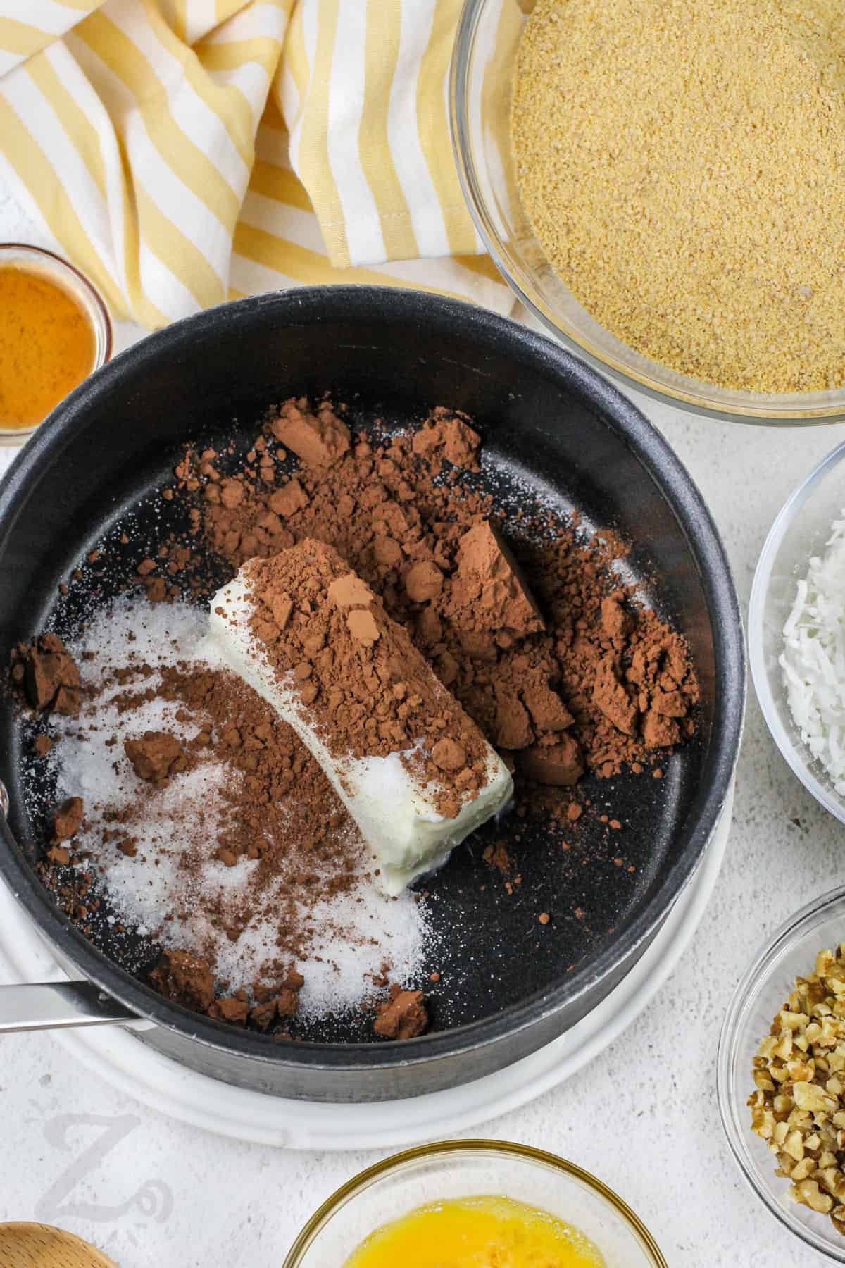 cocoa powder, butter, and sugar in a pot for Nanaimo Bars