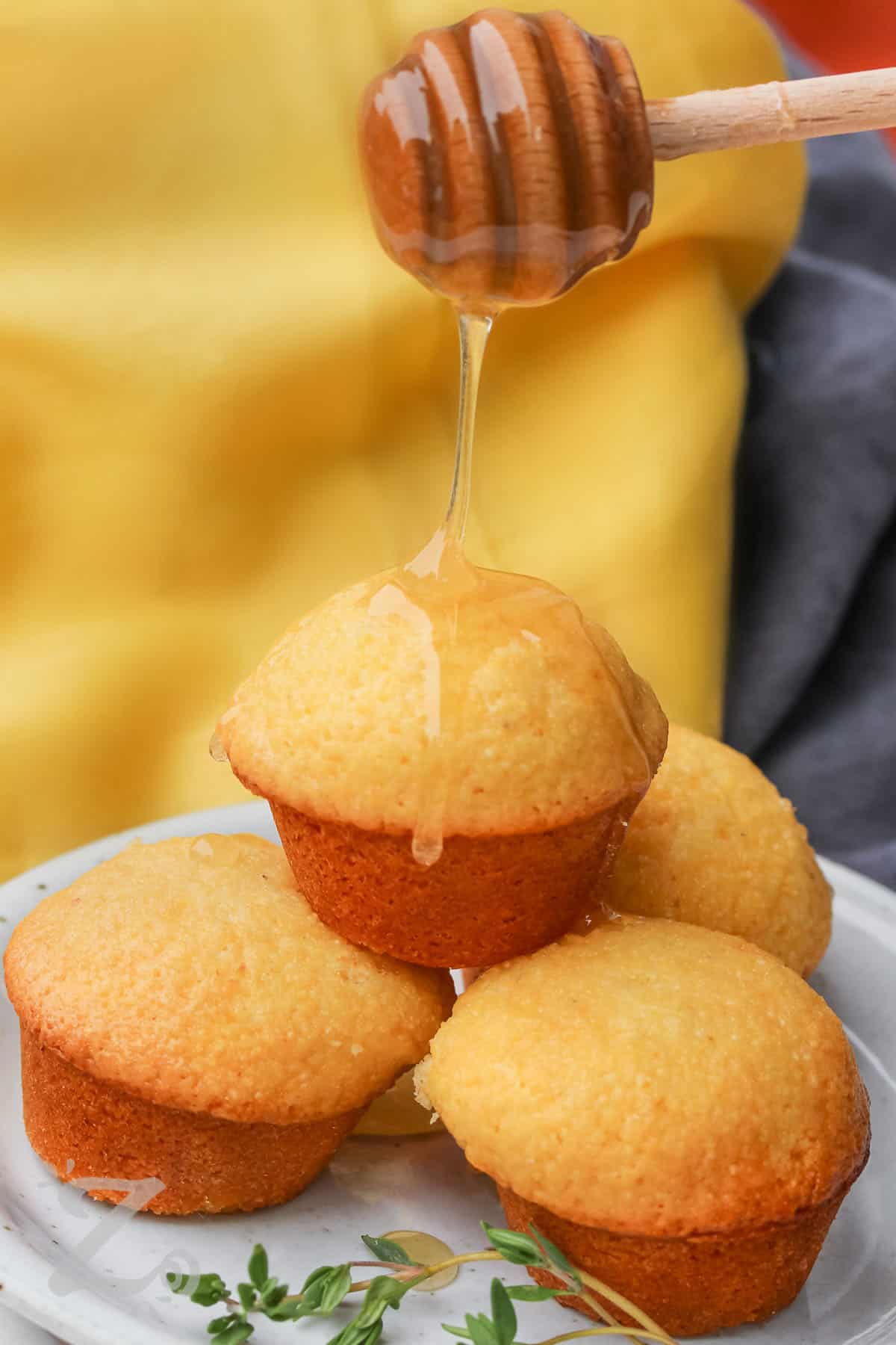 honeycomb with honey dripping on Honey Cornbread Muffin