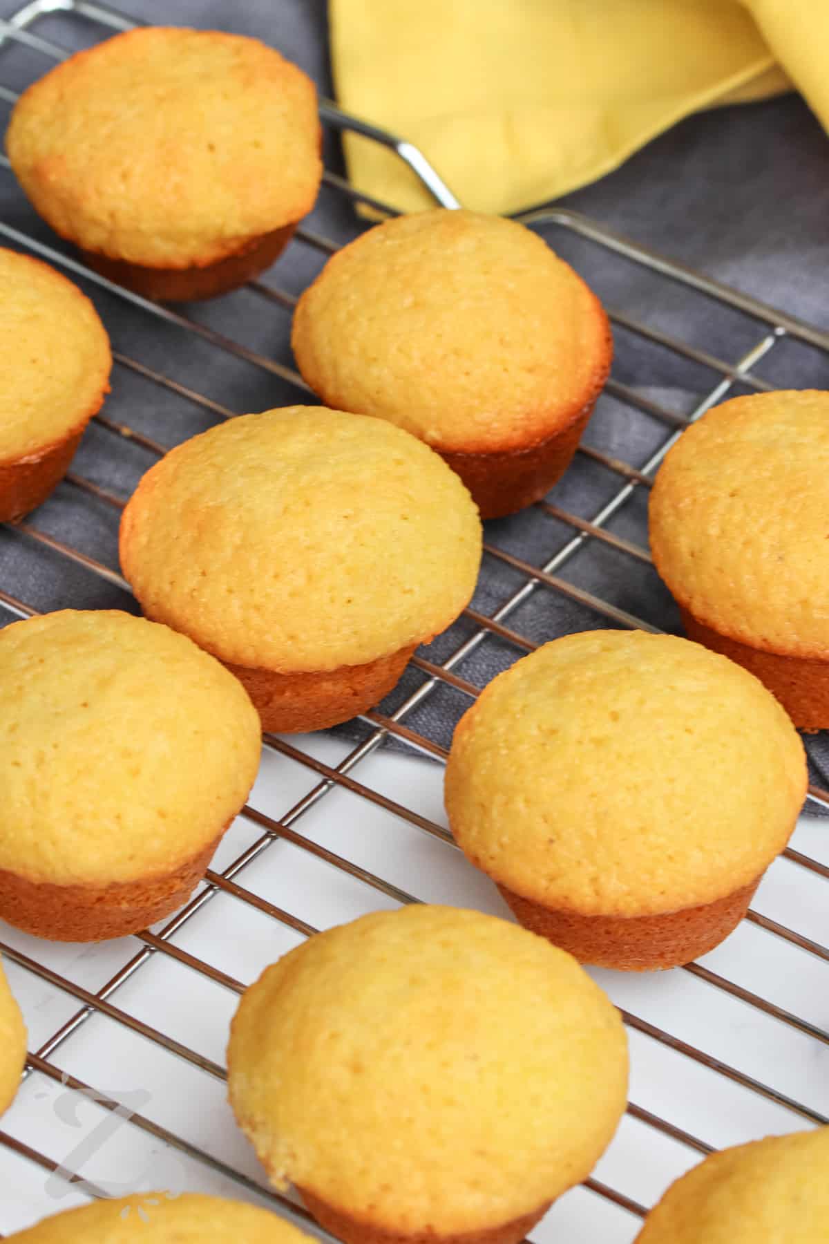 Honey Cornbread Muffin cooling on a metal rack