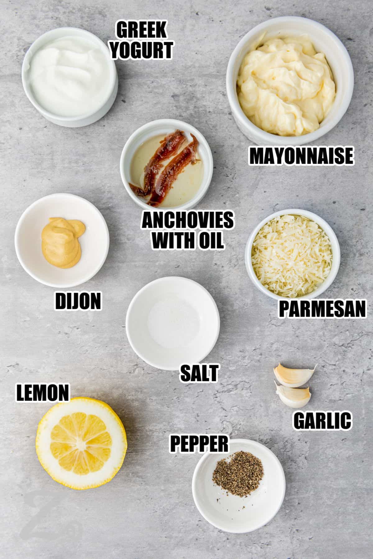 greek yogurt , mayonnaise , anchovies with oil , dijon , salt , parmesan , garlic , lemon , pepper with labels to make Caesar Salad Dressing
