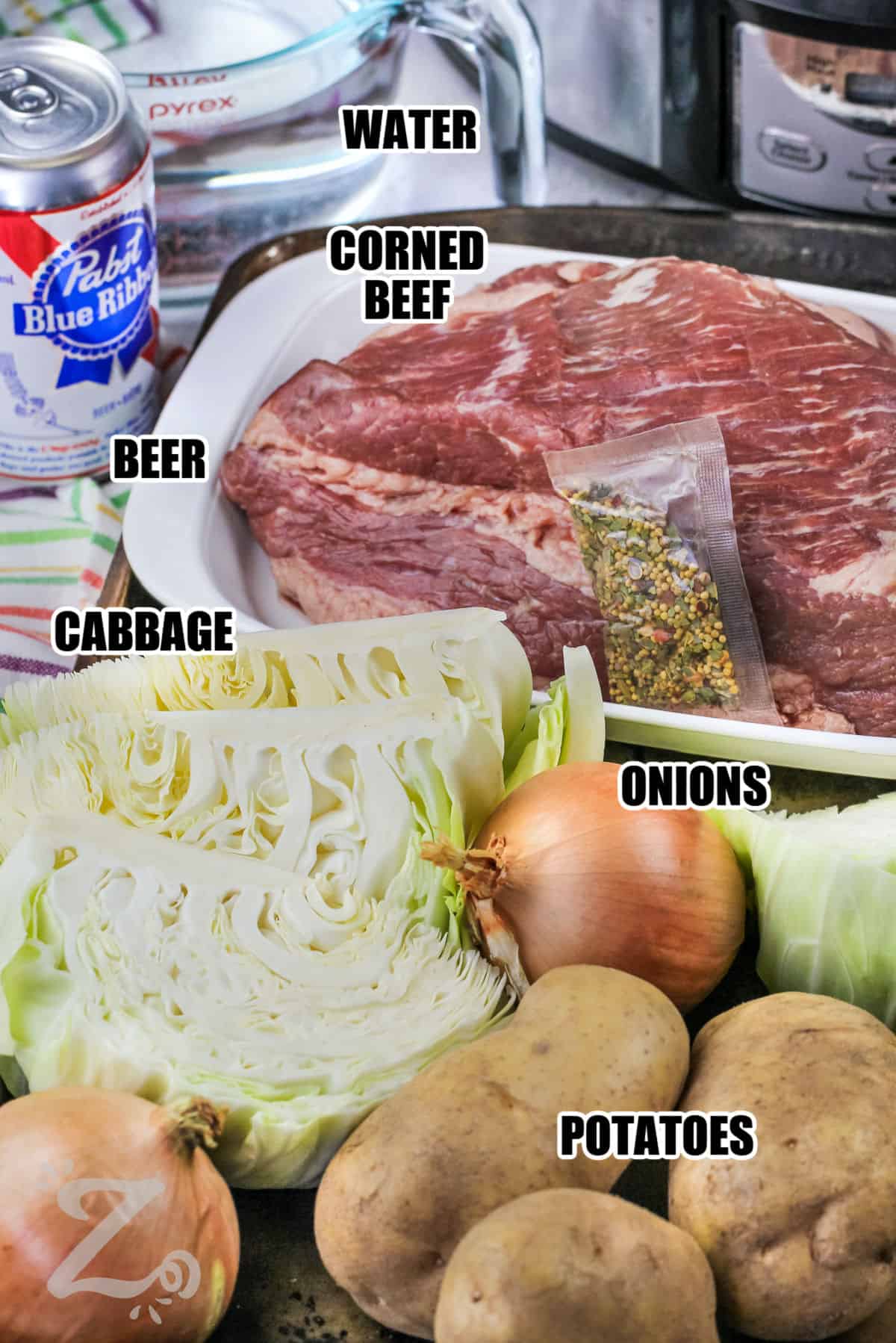 corned beef , water , beer , cabbage , onions , and potatoes with labels to make Slow Cooker Corned Beef and Cabbage