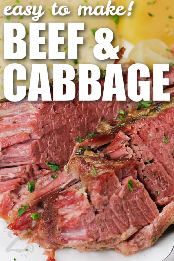 close up of plated Slow Cooker Corned Beef and Cabbage with a title