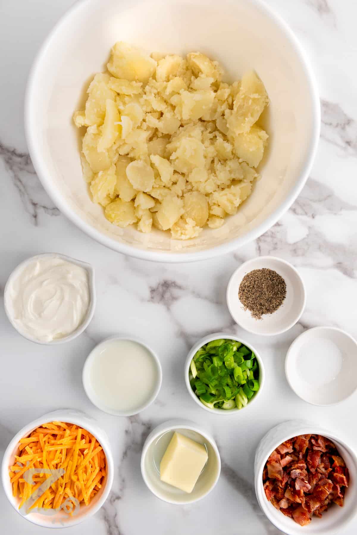 ingredients in bowls to make Twice Baked Potatoes