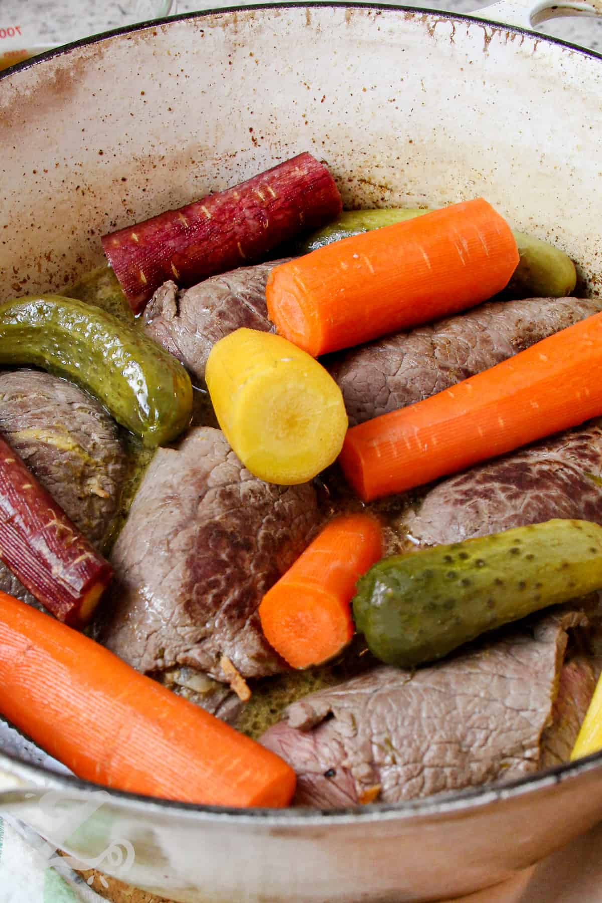 cooked Beef Rouladen with vegetables in a pot