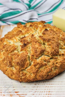 loaf of Best Irish Soda Bread Recipe with a bar of butter