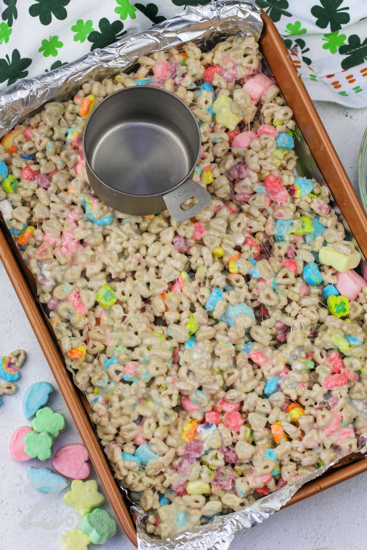 adding Homemade Lucky Charms Bars to the dish