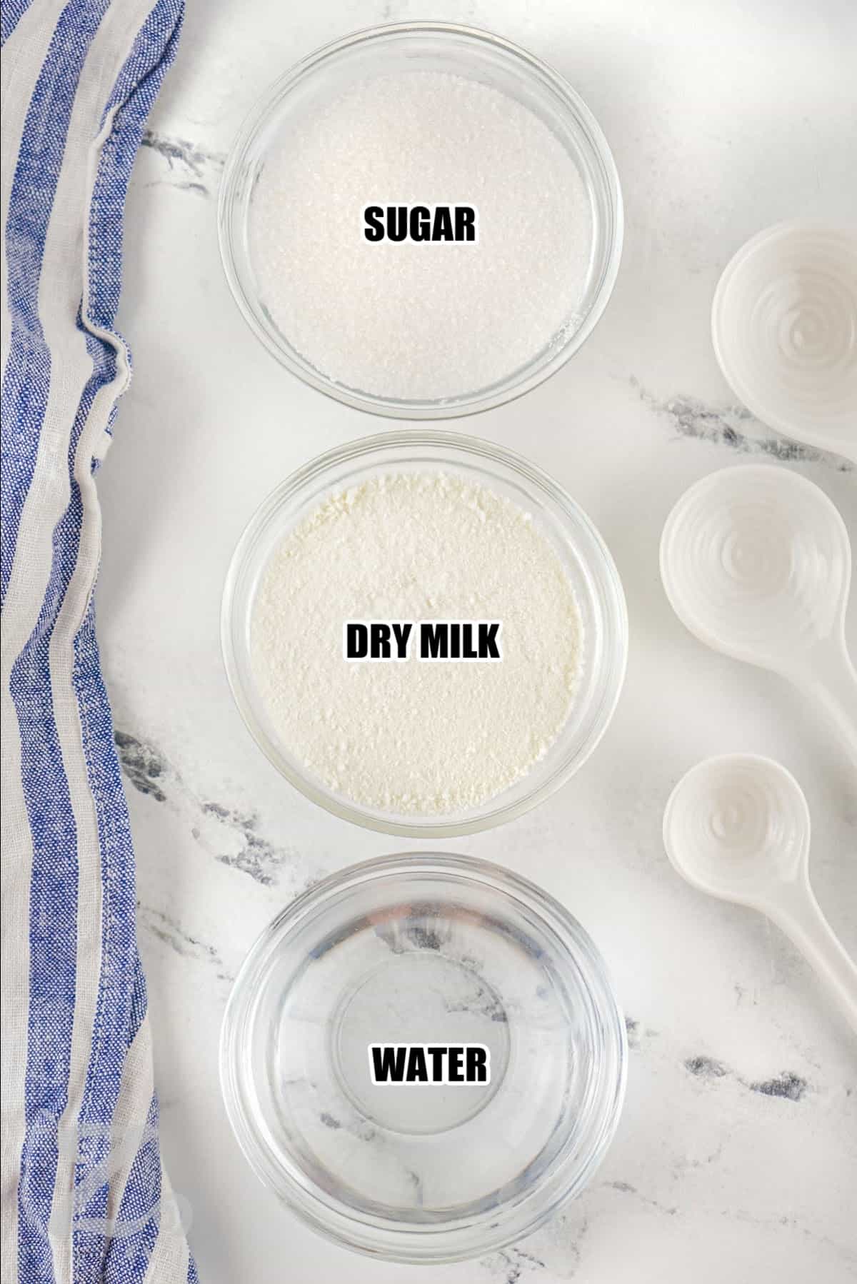 ingredients to make sweetened condensed milk labeled: sugar, dry milk, and water.