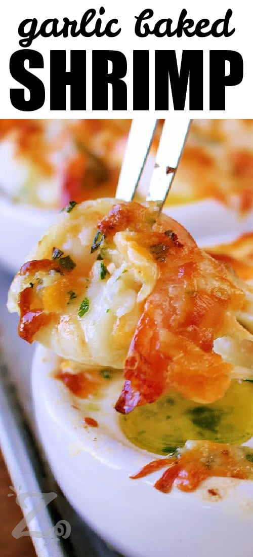 a cheesy garlic baked shrimp being pulled with a shrimp fork from an escargot dish, with a title