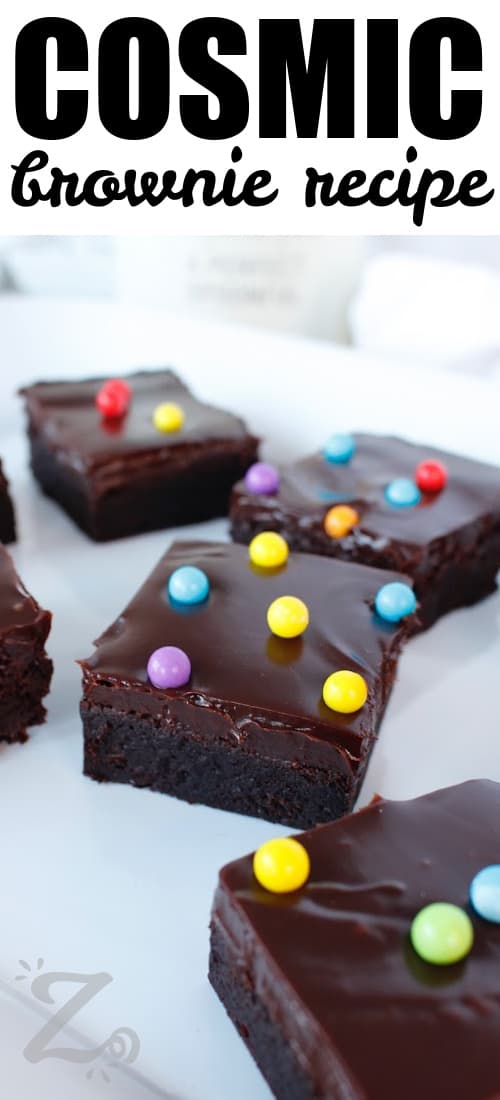 pieces of cosmic brownie recipe on a white dish with writing