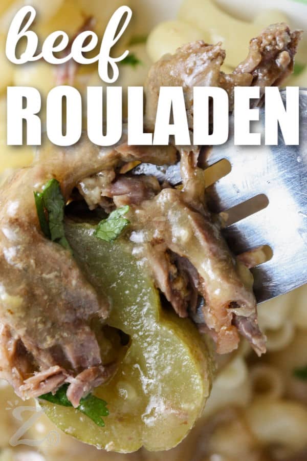 close up of Beef Rouladen on a fork with a title