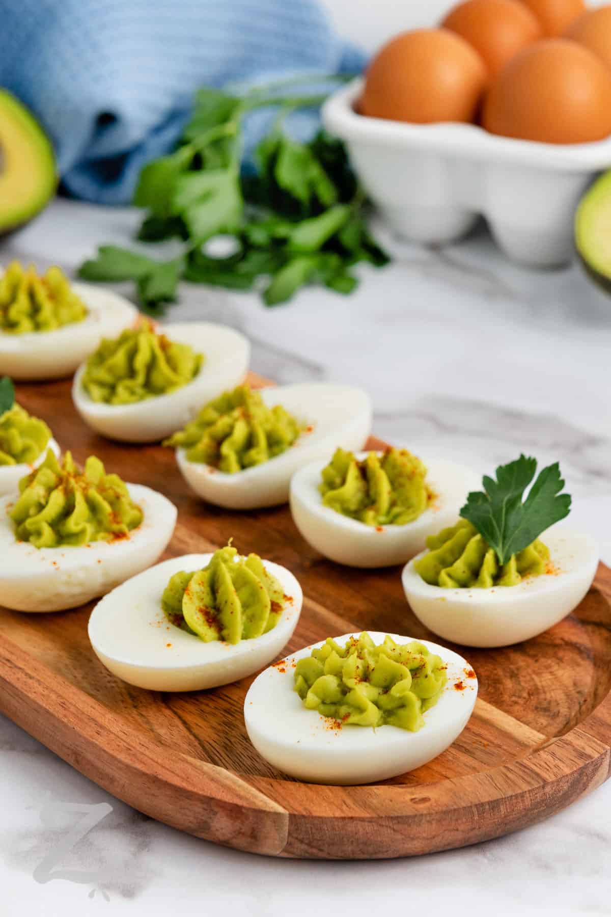 avocado deviled eggs on a serving board