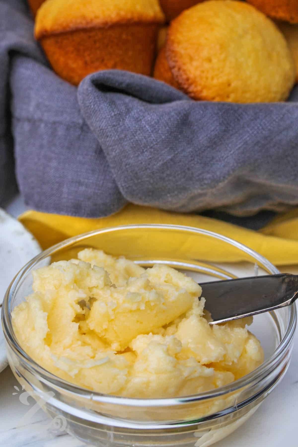 Honey Butter in a bowl with a basket of muffins
