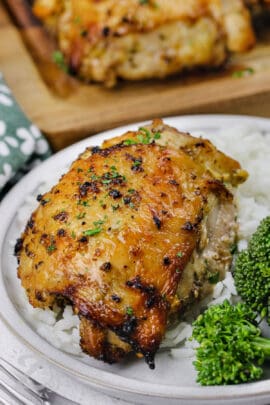 a serving of Lemon Pepper Chicken Thighs with rice on a plate