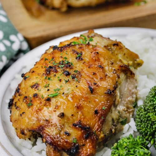 a serving of Lemon Pepper Chicken Thighs with rice on a plate