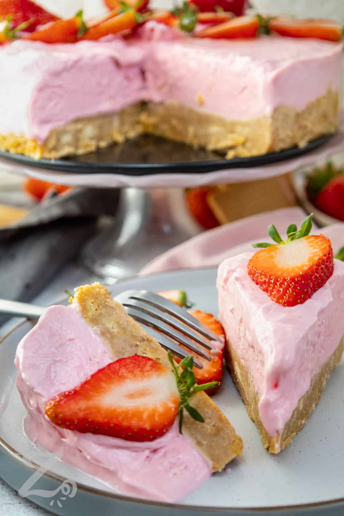 two slices of no bake strawberry cheesecake on a plate