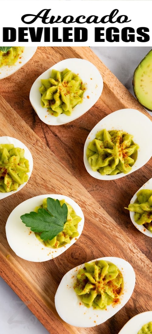 avocado deviled eggs on a serving board with a title