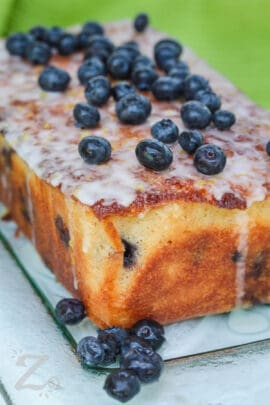 lemon blueberry loaf with glaze and fresh blueberries on top