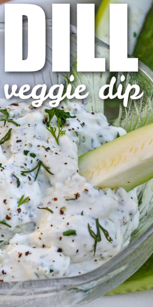 dipping cucumber in easy Dillionaire Veggie Dip with a title