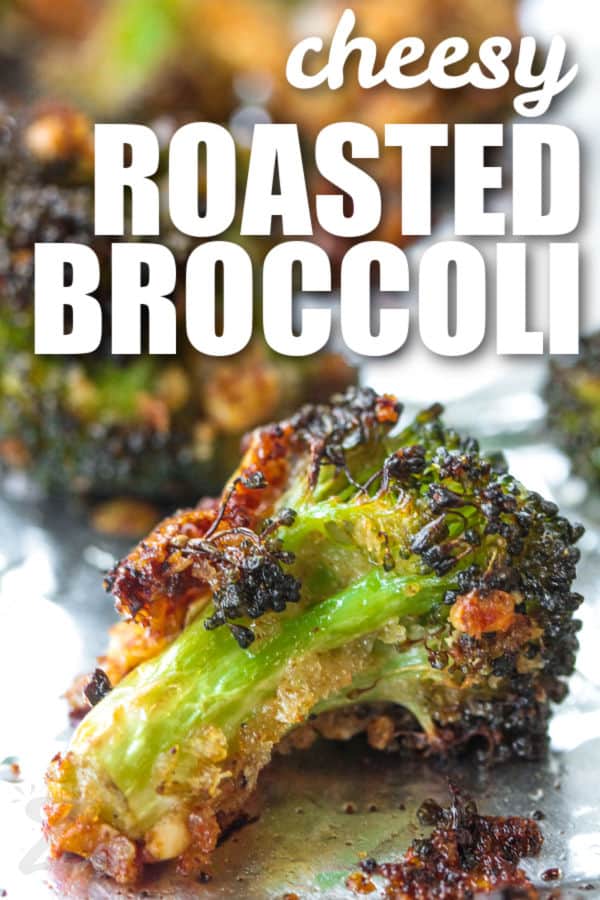 close up of Parmesan Roasted Broccoli on a sheet pan with a title