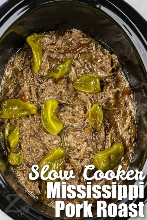 Shredded Mississippi Pork Roast in a slow cooker with pepperoncini peppers and a title