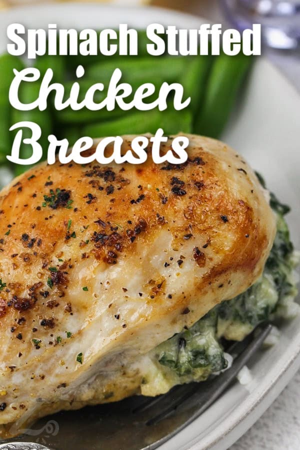 Spinach Stuffed Chicken Breasts on a plate with green beans and a title