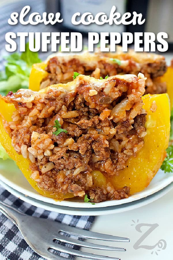 one slow cooker stuffed pepper cut in half on a white plate, with a title
