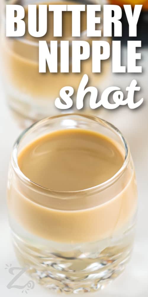 close up of simple Buttery Nipple Shot in a shot glass with a title