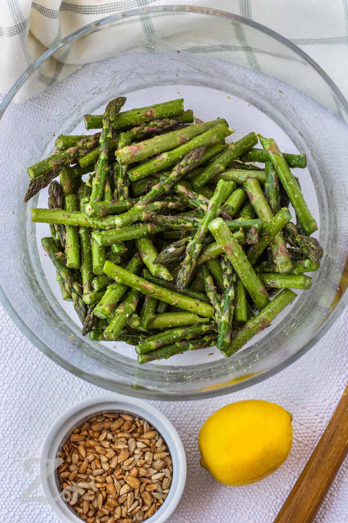 seasoned asparagus in a bowl to make Sauteed Asparagus