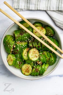 bow of Korean Cucumber Salad with chop sticks on top