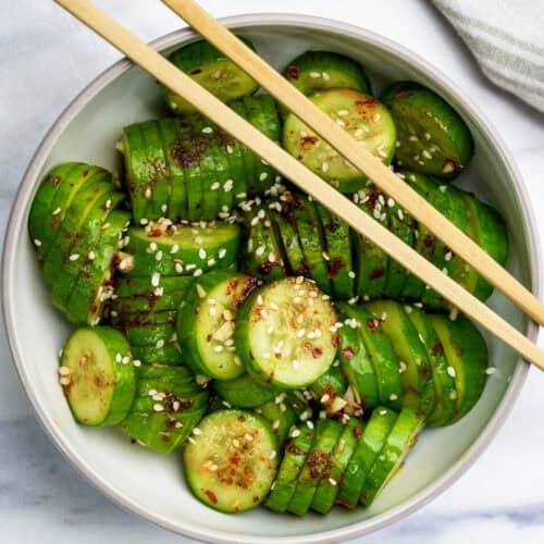 bow of Korean Cucumber Salad with chop sticks on top