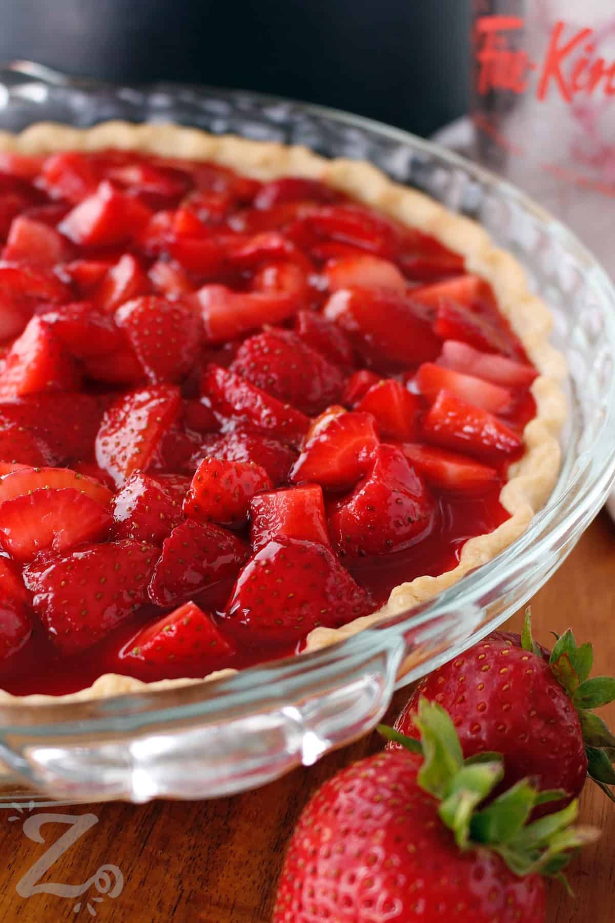 close up of fresh strawberry pie, made with glaze covered strawberries in a baked pie shell