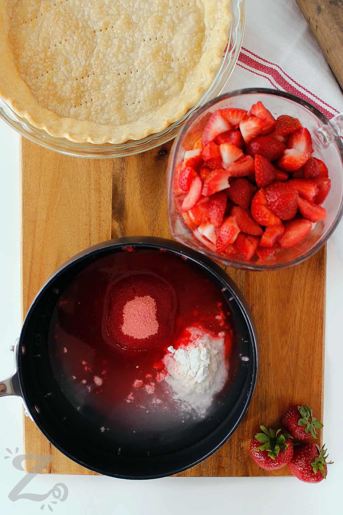 water, sugar, cornstarch and strawberry Jell-o in a pot with strawberries and baked pie shell on the side, to make Fresh Strawberry Pie