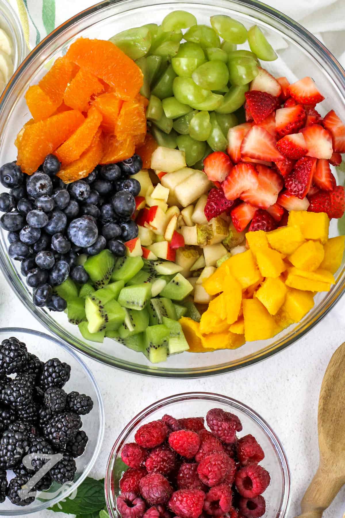 fruit in a clear bowl to make this delish recipe for fruit salad