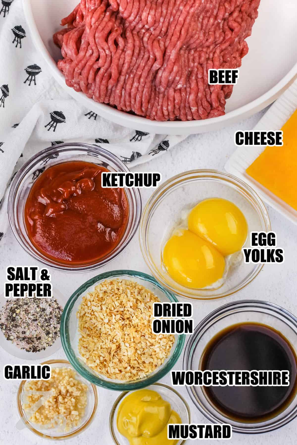 beef , ketchup , cheese , egg yolks , dried onion , worcestershire , mustard , garlic , salt and pepper with labels to make Hamburger Patties
